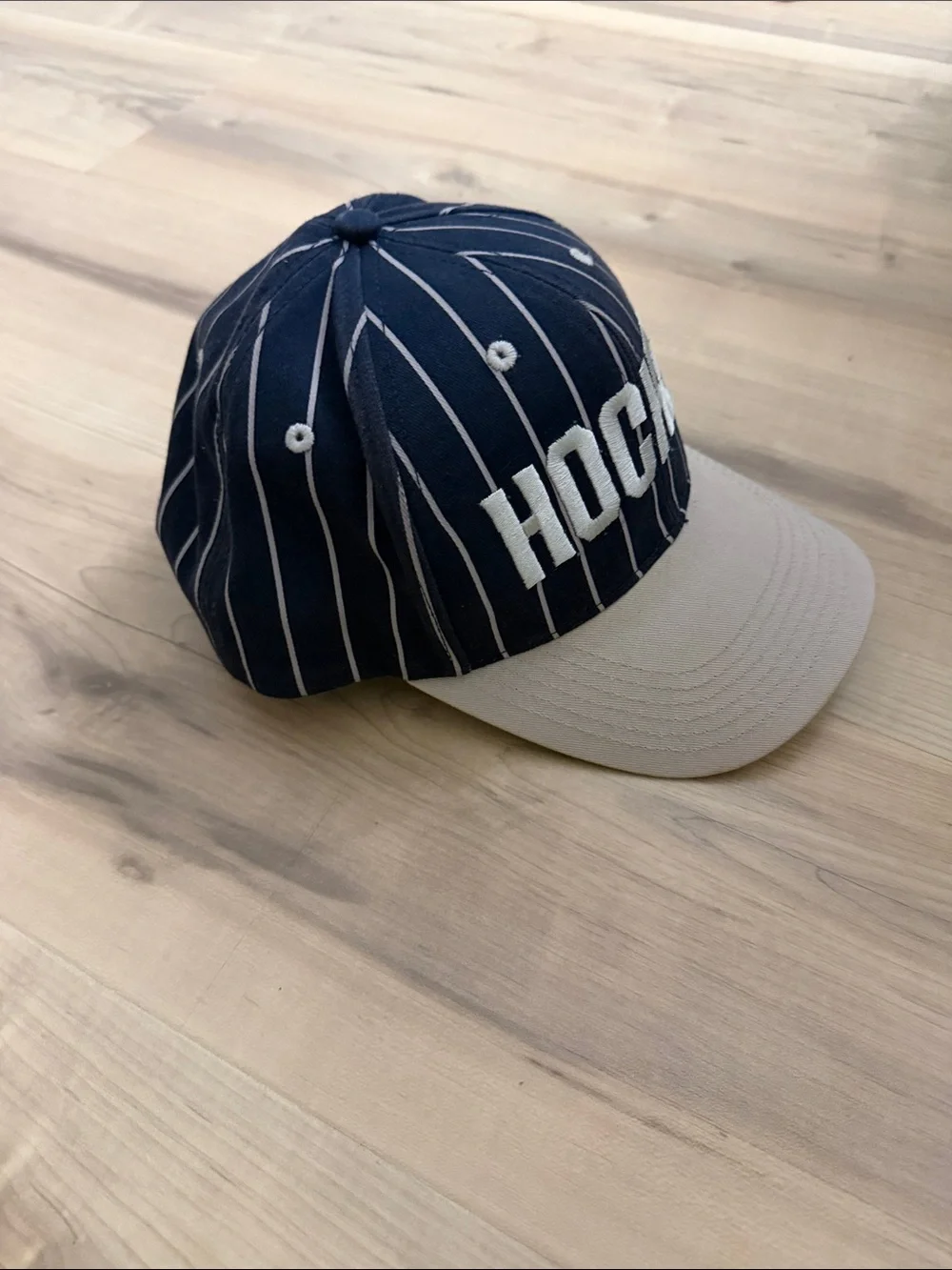 Hockey eyes without a face white and navy striped hat